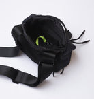 Black waist bag with a strap on a white background