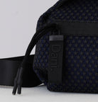 Black textured bag with visible brand logo on a light gray background